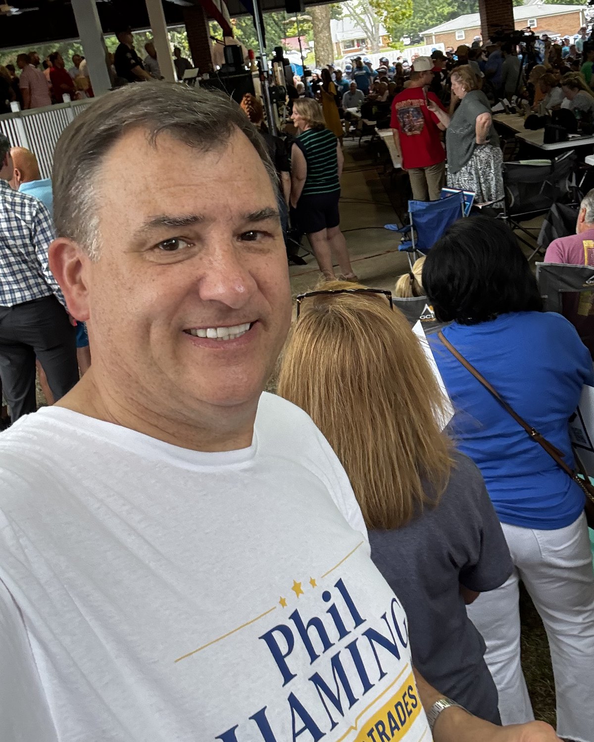 Phil Haming in a campaign T-shirt at an outdoor political event